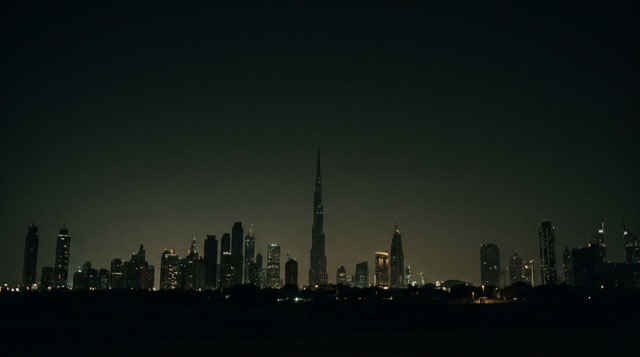 The Dubai skyline at night in light desert haze